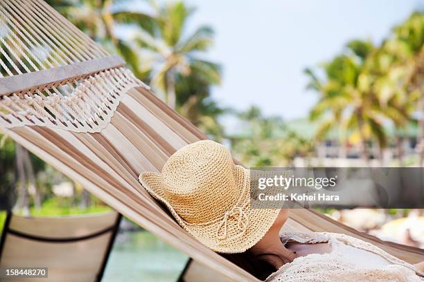 a woman sleeping on hammock - woman face hat foto e immagini stock