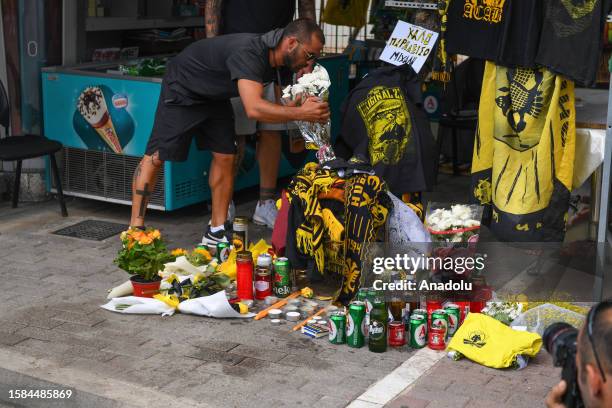 Man lays flowers in the memory of 29-year-old Greek fan died during the overnight clashes between rival supporters in Nea Filadelfeia, Athens, Greece...
