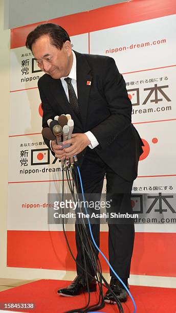 New Party Nippon leader Yasuo Tanaka bows to his supporters after losing in the Hyogo No.8 Constituency at his campaign headquarters on December 16,...
