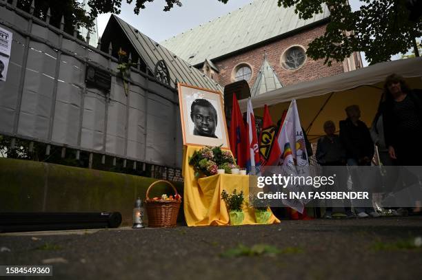 Mourners pay their respects at a makeshift memorial for Mouhamed Lamine Drame from Senegal during a memorial service at the site where he died in...