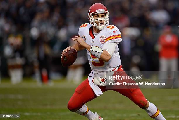 Brady Quinn of the Kansas City Chiefs rolls out to pass against the Oakland Raiders in the third quarter at Oakland-Alameda County Coliseum on...