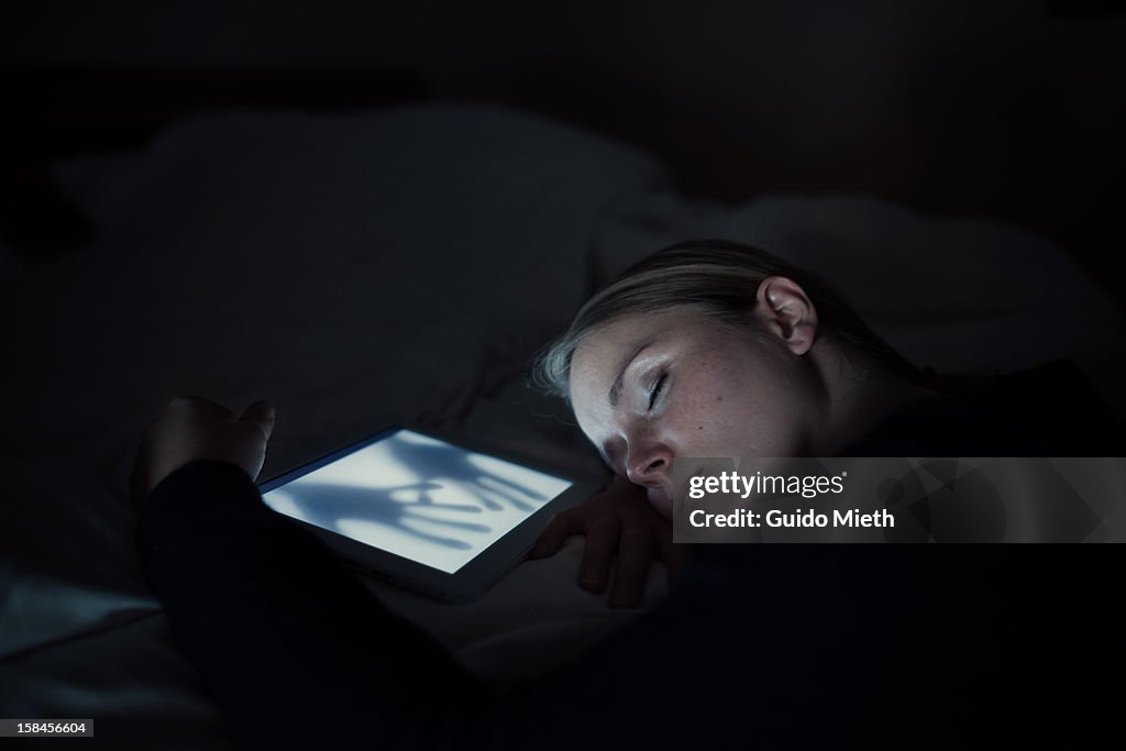 Woman sleeping near tablet pc.