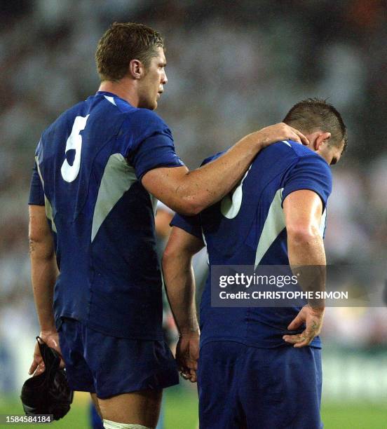 French prop Sylvain Marconnet and French lock Jerome Thion look dejected after losing their Rugby World Cup semi-final match between France and...