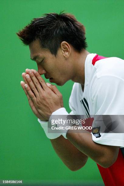 Paradorn Srichaphan of Thailand gives a traditional "wai", or bow, to the crowd following his loss to Andre Agassi of the US in the men's singles...
