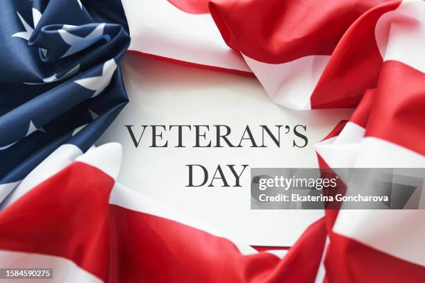 veteran's day text on the american flag - us veteran's day stock pictures, royalty-free photos & images