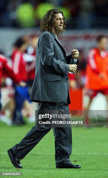 Senegal's coach Bruno Metsu of France walks over the field after his team lost 0-1 against Turkey in overtime of match 60 of the 2002 FIFA World Cup...