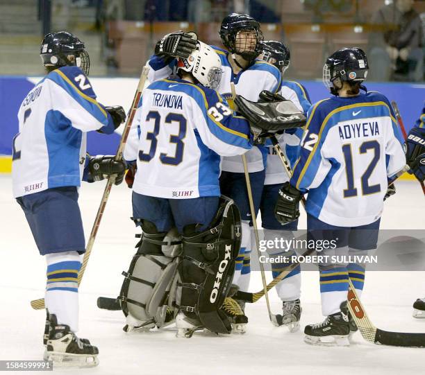 Anna Akimbetyeva of Kazakhstan is consoled by her teamates after losing their Women's Ice Hockey preliminary round game against Canada 11 February...