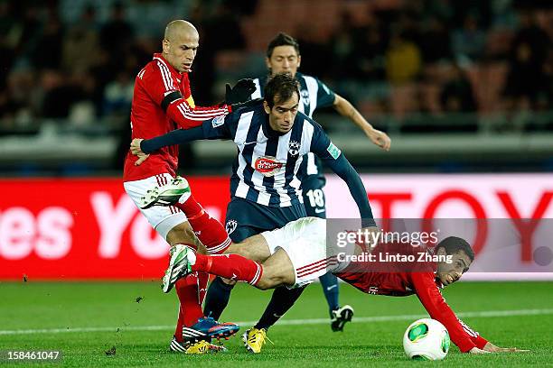 Jose Maria Basanta of CF Monterrey challenges Wael Gomaa and Ahmed Fathi during the FIFA Club World Cup 3rd Place Match between Al-Ahly SC and CF...