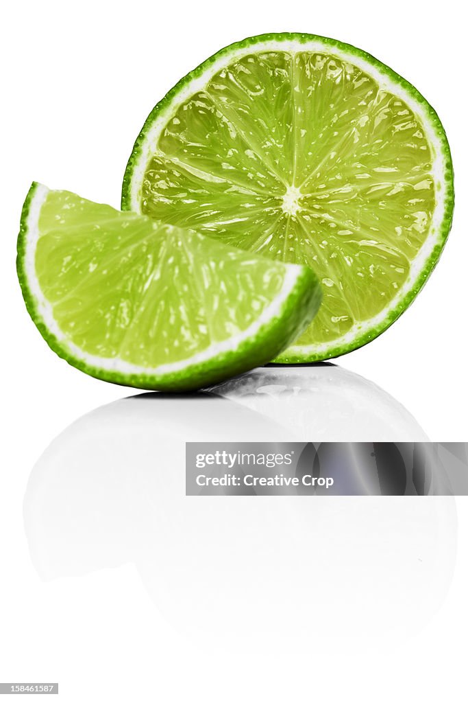A lime cut in half with a wedge