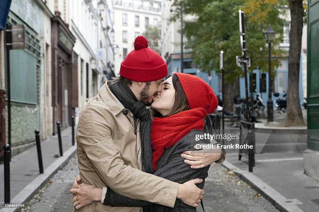 Young couple kissing in the middle of a street