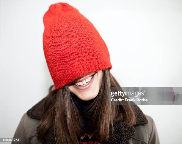 young girl with long brown hair and a red cap on - knit hat stock pictures, royalty-free photos & images