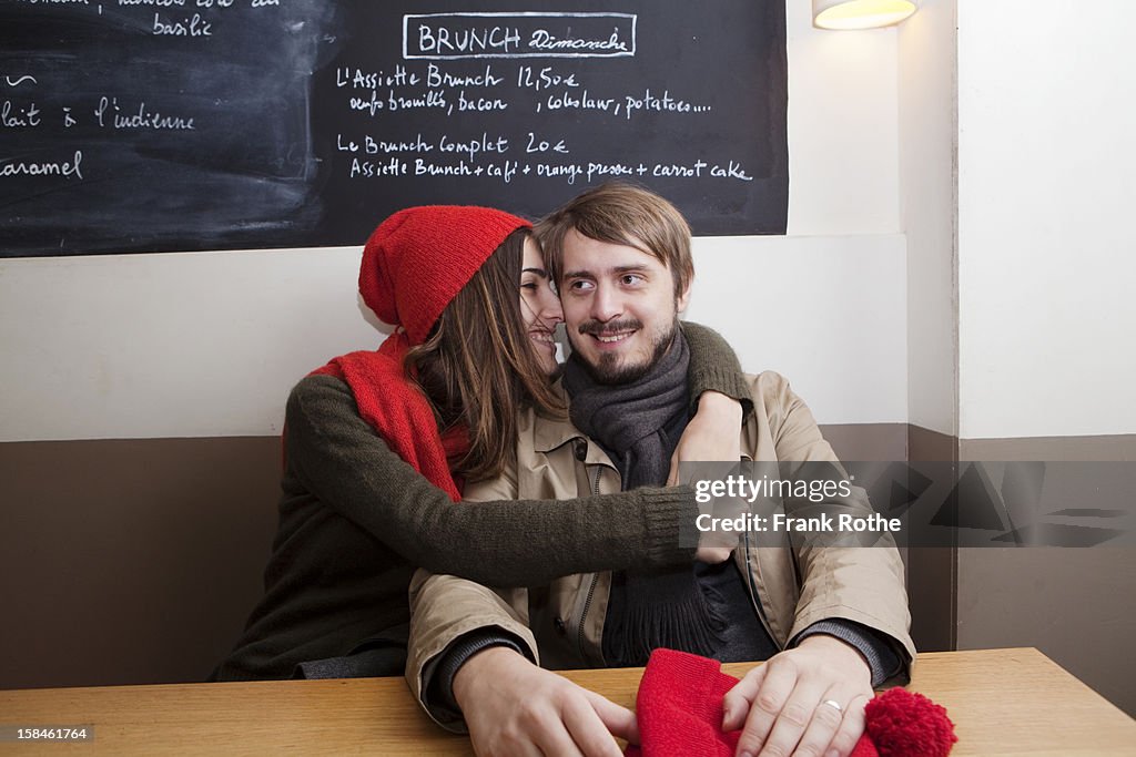Young couple inside a restaurant embracing