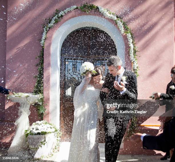 wedding guests throwing rice at bride and groom - throwing flowers stock pictures, royalty-free photos & images