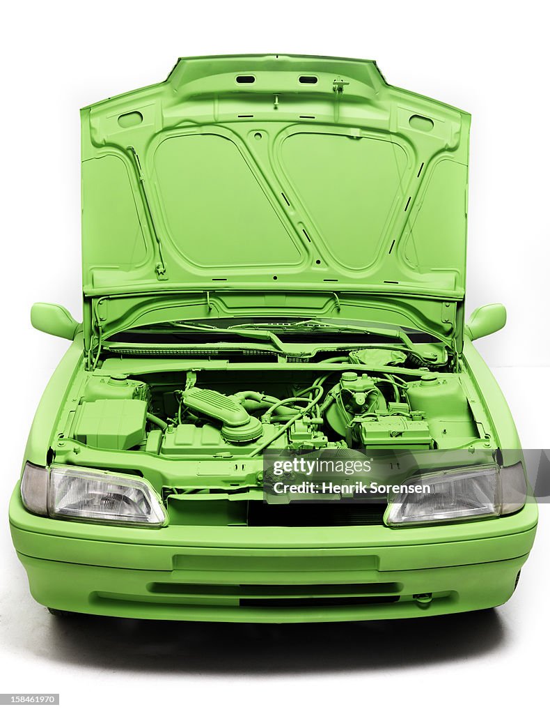 Green car, environment. (The front of the car)