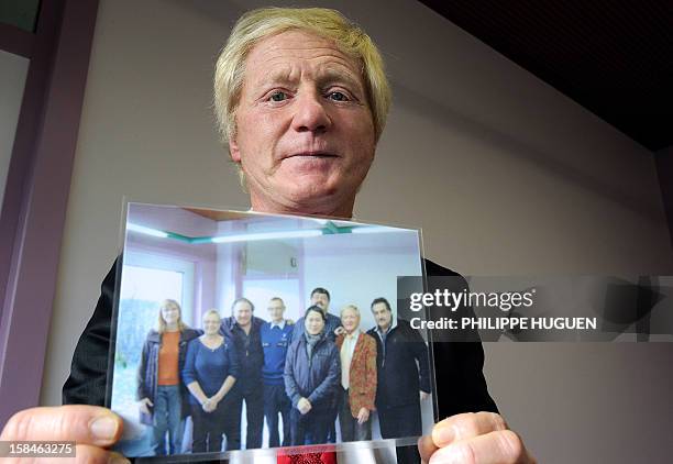 The Bourgmestre of Estaimpuis Daniel Senesael displays a picture showing French actor Gerard Depardieu posing with members of the municpal council on...