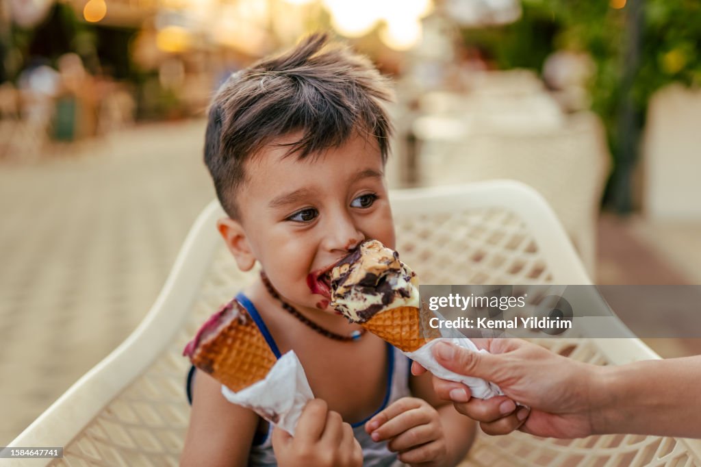 Cute little boy enjoy eating ice cream at summer