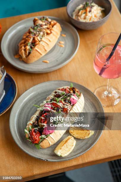 eating out at restaurant with fried sandwich buns with chicken, vegetables, drink and fries - jalapeno pepper stock pictures, royalty-free photos & images