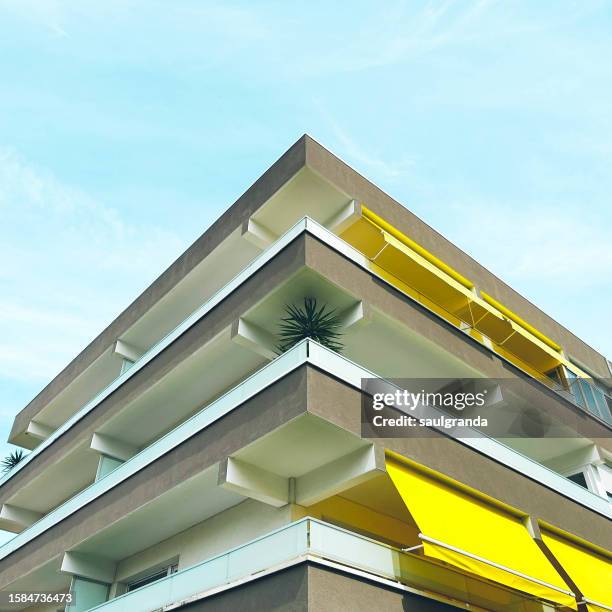 low angle view of an apartment building in beach area - awning stock pictures, royalty-free photos & images