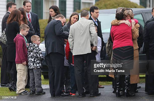 Mourners embrace as others wait to enter Honan Funeral Home before the funeral for six-year-old Jack Pinto on December 17, 2012 in Newtown...