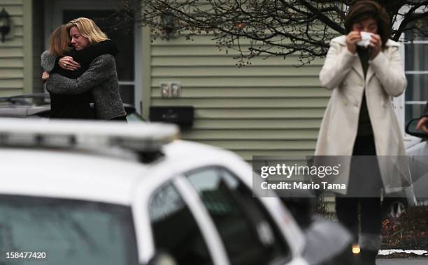 Mourners embrace while deparing Honan Funeral Home after the funeral for six-year-old Jack Pinto on December 17, 2012 in Newtown Connecticut. Pinto...