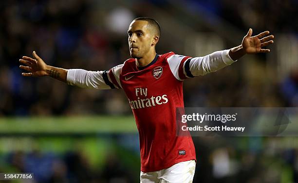 Theo Walcott of Arsenal celebrates after scoring their fifth goal during the Barclays Premier League match between Reading and Arsenal at Madejski...