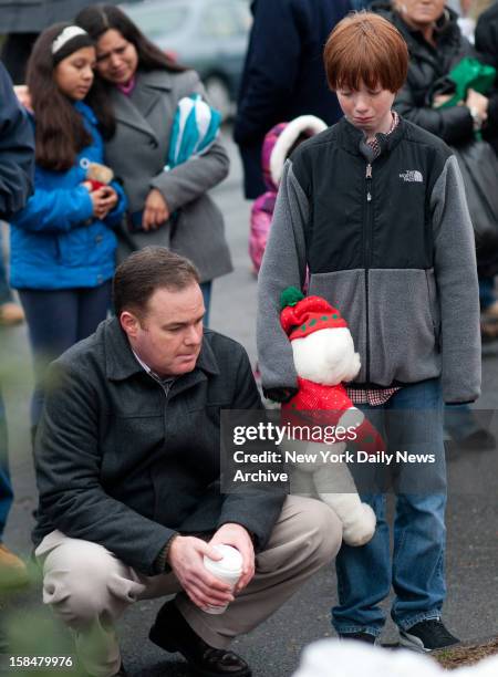 Newtown community comes together outside the firehouse to mourn the loss of 27 people including 20 children in the Sandy Hook Elementary School...