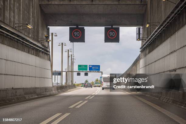 tunnel with a multilane highway leading into denmark - malmo stock pictures, royalty-free photos & images