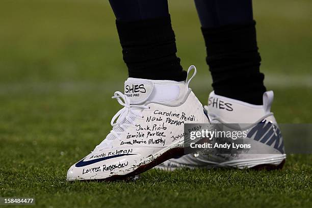 Detailed view of running back Chris Johnson of the Tennessee Titans cleats that show the names of the victims of the mass shooting that took place at...