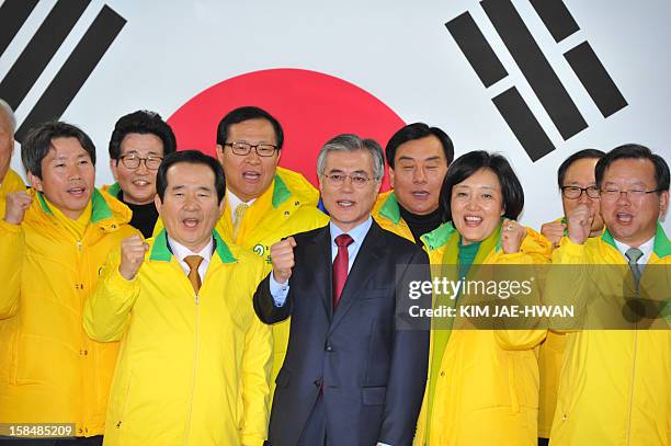 South Korea's presidential candidate Moon Jae-In of the opposition Democratic United Party cheers with party members after a press conference at...