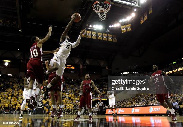 Keion Bell of the Missouri Tigers shoots on a fast break as Patrick Myers of the South Carolina State Bulldogs defends during the game at Mizzou...