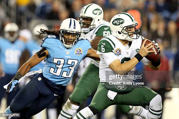 Quarterback Mark Sanchez of the New York Jets looks to throw the ball against free safety Michael Griffin of the Tennessee Titans at LP Field on...