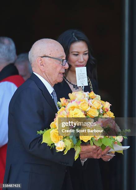 Rupert Murdoch carries flowers as he leaves with his wife Wendi Deng Murdoch after attending the Dame Elisabeth Murdoch public memorial at St Paul's...