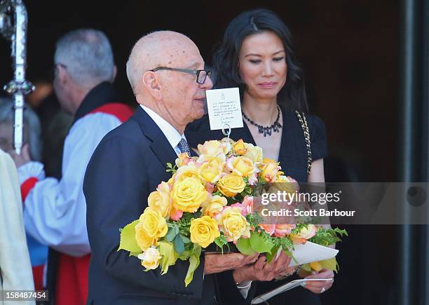 Rupert Murdoch carries flowers as he leaves with his wife Wendi Deng Murdoch after attending the Dame Elisabeth Murdoch public memorial at St Paul's...