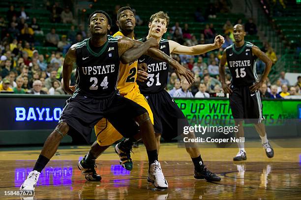 Jodd Maxey and Mario Blessing of the USC Upstate Spartans box out A.J. Walton of the Baylor University Bears on December 17, 2012 at the Ferrell...