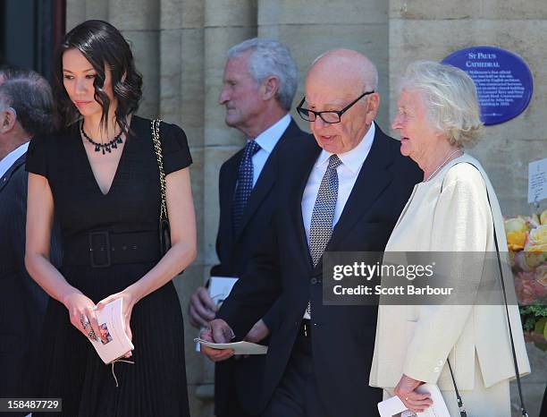 Rupert Murdoch talks with his sister Janet Calvert-Jones as his wife Wendi Deng Murdoch looks on as they leave after attending the Dame Elisabeth...