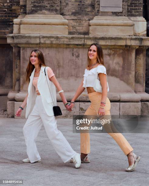 two teenage sisters walk briskly through the city - 15 year old model stock pictures, royalty-free photos & images