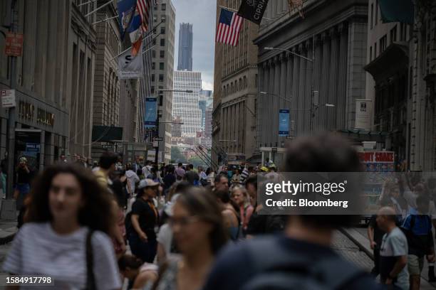 Pedestrians on Wall Street in New York, US, on Tuesday, Aug. 8, 2023. Stocks fell around the world as traders rushed into bonds after a raft of news...
