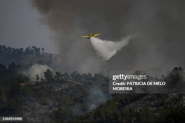 Firefighter plane drops water over a wildfire in Odeceixe, south of Portugal, on August 8, 2023. Hundreds of firefighters were today battling a...