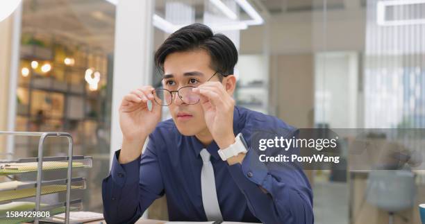 man eyes pain at work - presbyopia stock pictures, royalty-free photos & images