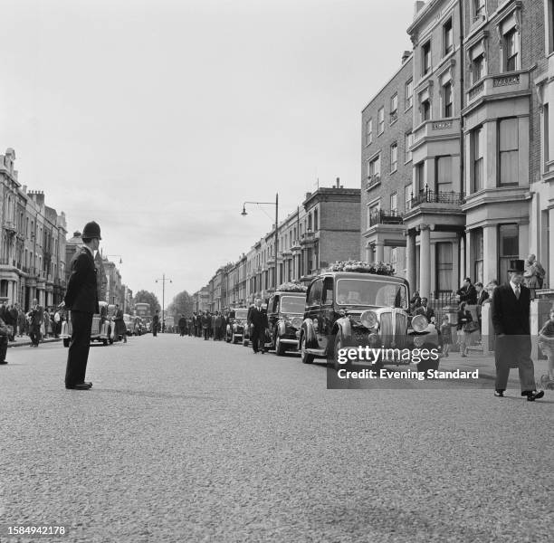 The funeral procession of Kelso Cochrane travelling from Ladbroke Grove to Kensal Green, London, June 6th, 1959. Cochrane was murdered by a gang of...