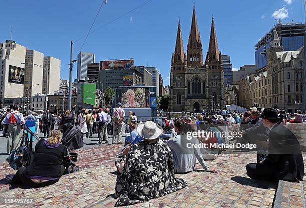 People at Federation Square watch the Dame Elisabeth Murdoch public memorial at St Paul's Cathedral on December 18, 2012 in Melbourne, Australia....