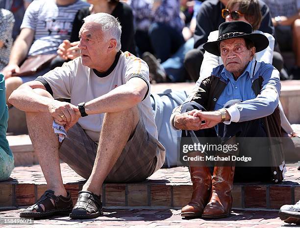 People at Federation Square watch the Dame Elisabeth Murdoch public memorial at St Paul's Cathedral on December 18, 2012 in Melbourne, Australia....