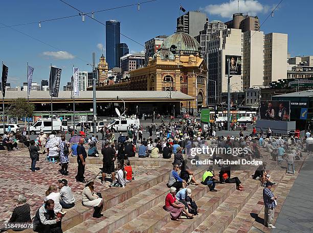 People at Federation Square watch the Dame Elisabeth Murdoch public memorial at St Paul's Cathedral on December 18, 2012 in Melbourne, Australia....