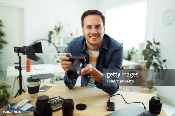 portrait of young handsome photographer at his home office - photographer stock pictures, royalty-free photos & images