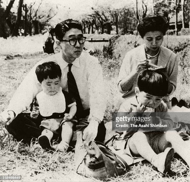 Circa 1956, Shintaro Abe , son-in-law of Foreign Minister Nobusuke Kishi, holding his second son Shinzo onto his lap, while dauther of Kishi and wife...