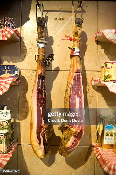 Two legs of dry-cured Jamon Iberico de Bellota hang from a wall in the jamon food shop of Alberto Lopez Araque on December 14, 2012 in Madrid, Spain....