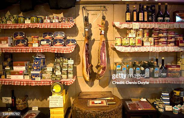 Two legs of dry-cured Jamon Iberico de Bellota hang from a wall in the jamon food shop of Alberto Lopez Araque on December 14, 2012 in Madrid, Spain....