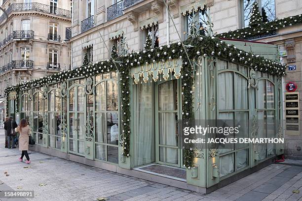 People walk past the Laduree restaurant on December 17, 2012 at the Champs-Elysees Avenue in Paris. AFP PHOTO /JACQUES DEMARTHON
