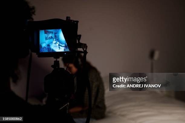 People interact with a simulated cam girl studio during an artificial intelligence exhibition called "Sex, Desire and Data," at the Centre Phi in...