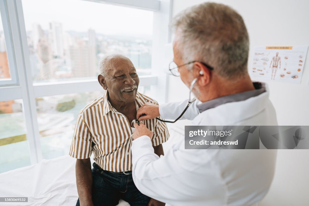 Portrait of a doctor listening to a patient's heartbeat
